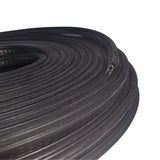 Coiled black rubber hose on a white background
